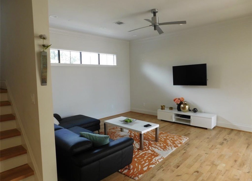 4506 Austin Street, Unit A Houston, TX 77004 - Photo 8 of 12 a living room with furniture and a flat screen tv