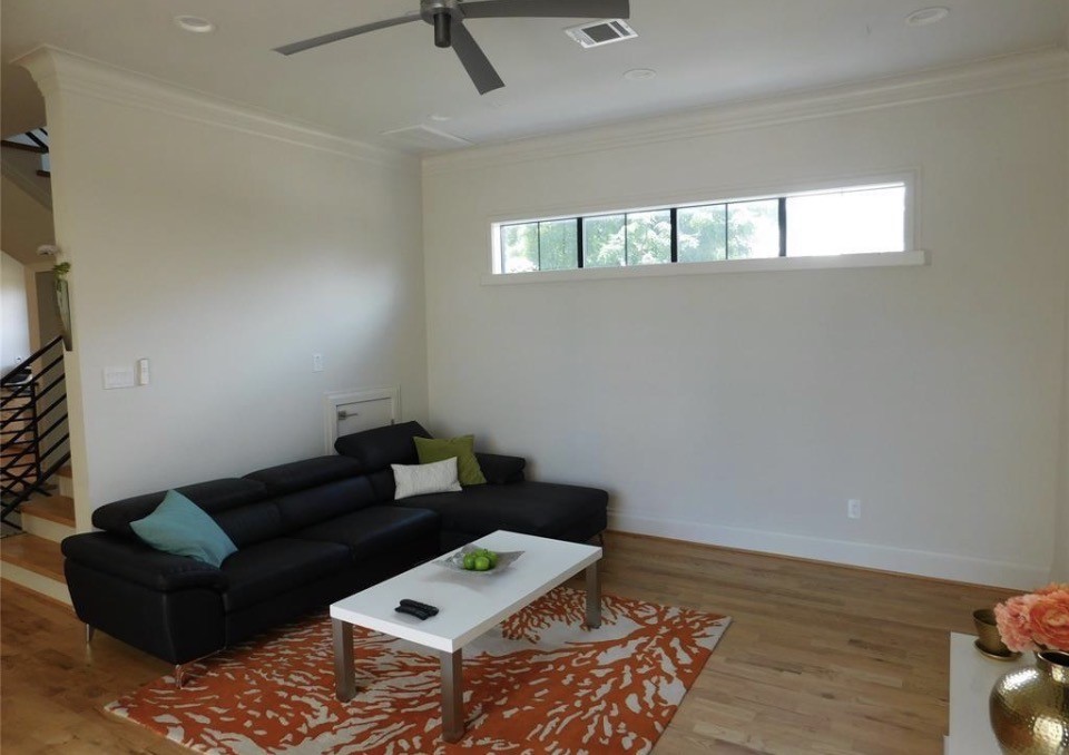 4506 Austin Street, Unit A Houston, TX 77004 - Photo 10 of 12 a living room with furniture and a wooden floor