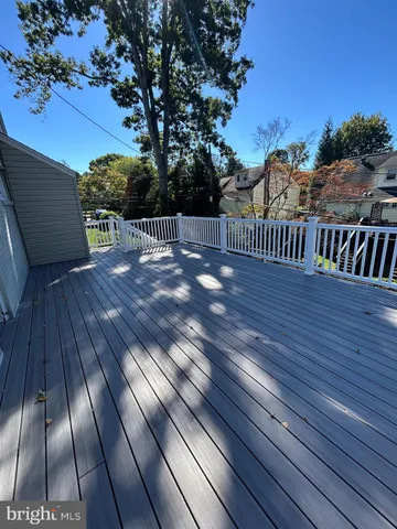 a view of balcony with wooden floor and fence