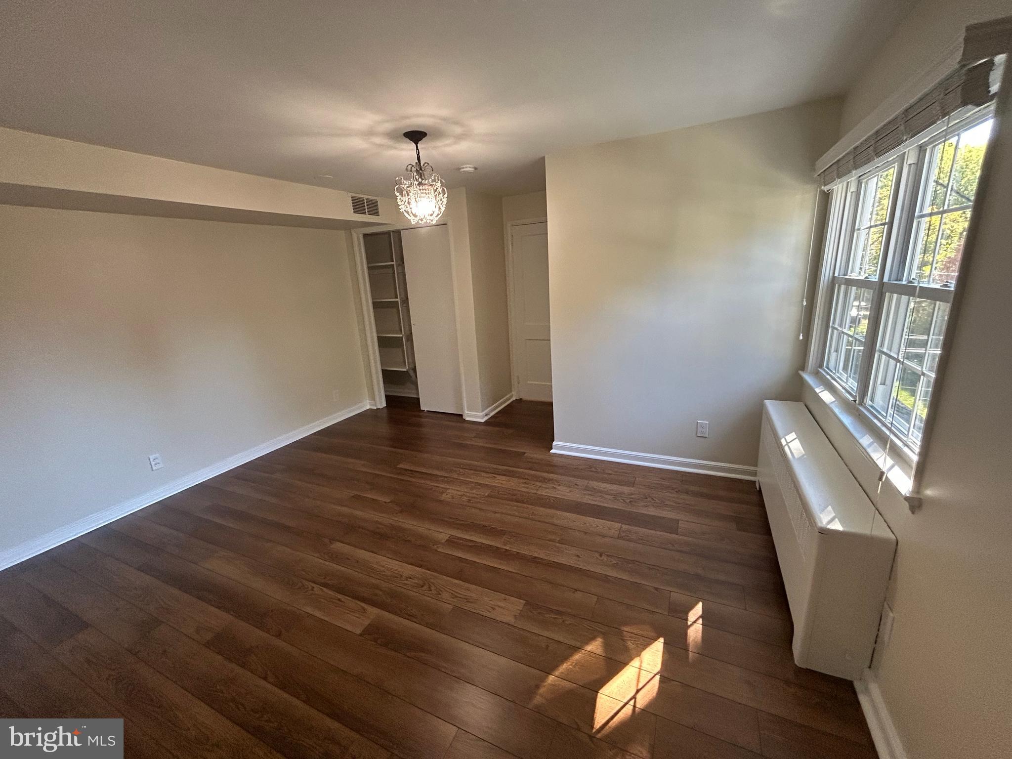 12 Rodney Road Bryn Mawr, PA 19010 - Photo 14 of 26 a view of an empty room with wooden floor and a window