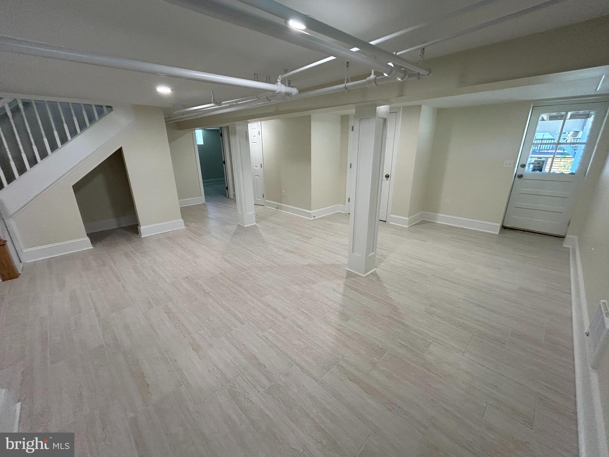 12 Rodney Road Bryn Mawr, PA 19010 - Photo 20 of 26 an empty room with wooden floor and windows