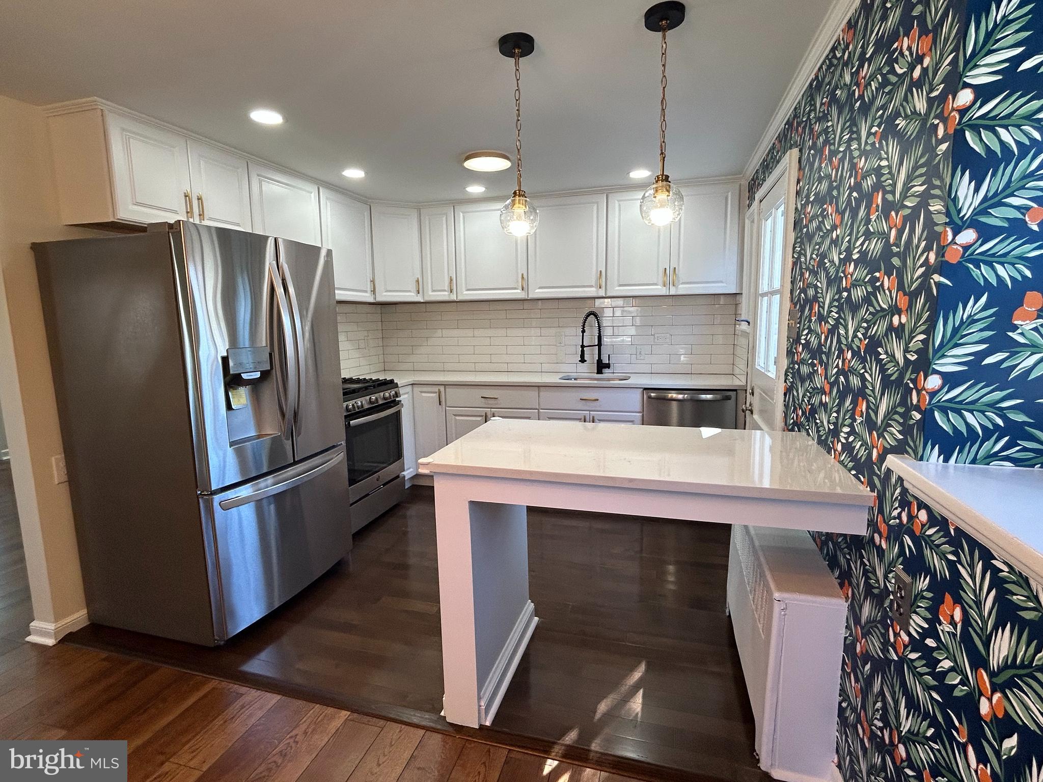12 Rodney Road Bryn Mawr, PA 19010 - Photo 4 of 26 a kitchen with kitchen island a sink stainless steel appliances and cabinets