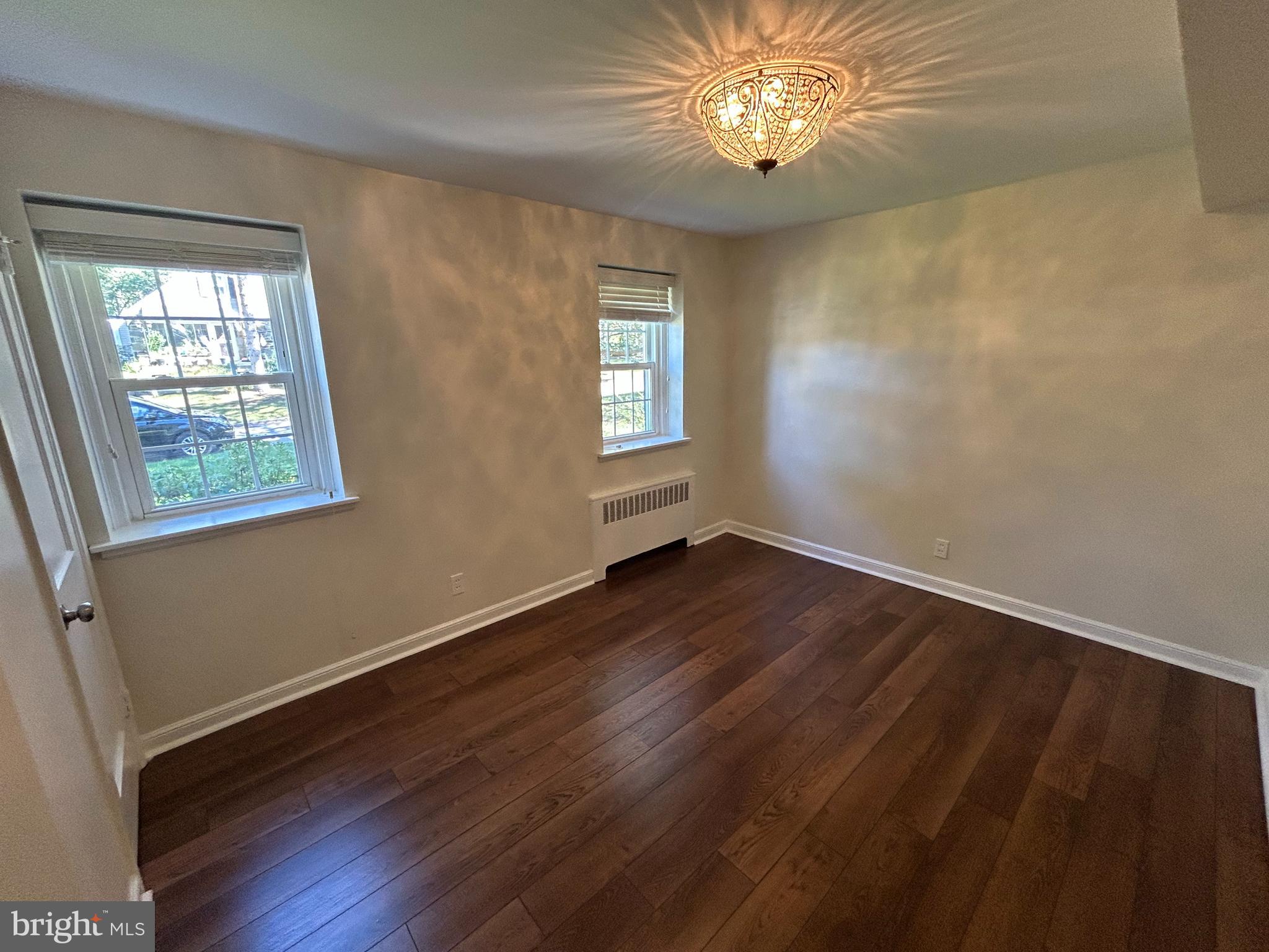 12 Rodney Road Bryn Mawr, PA 19010 - Photo 7 of 26 a view of an empty room with wooden floor and a window