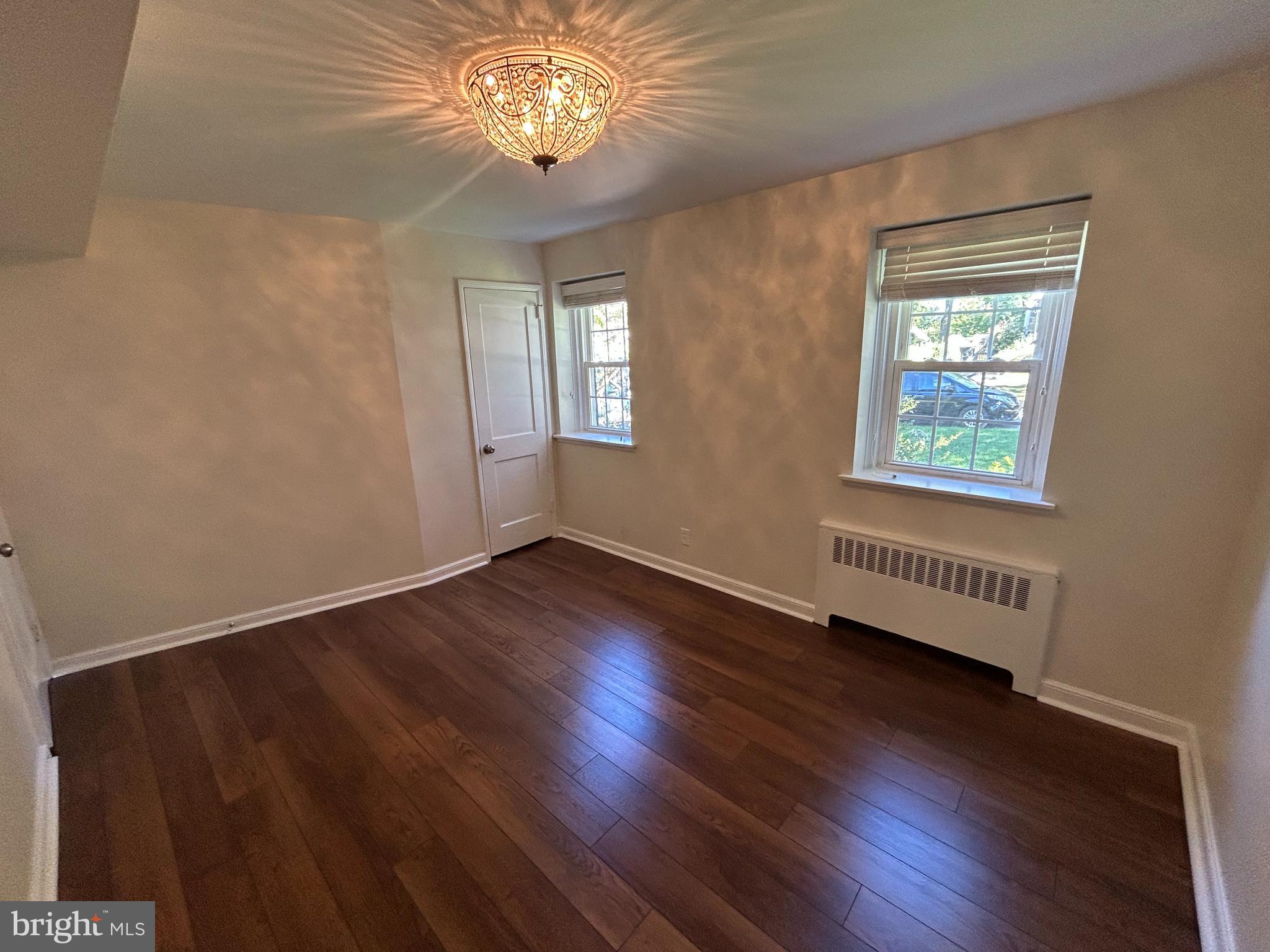 12 Rodney Road Bryn Mawr, PA 19010 - Photo 8 of 26 a view of an empty room with wooden floor and a window