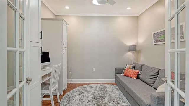 a bedroom with a bed and large windows