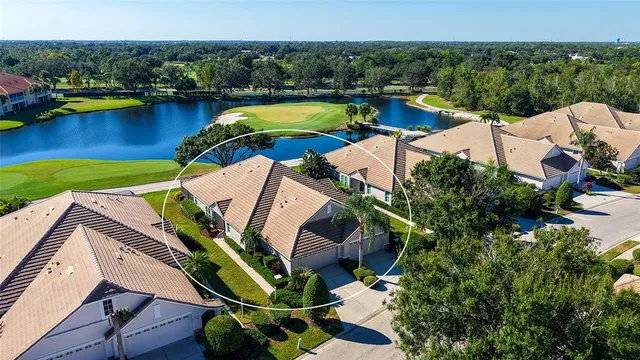 an aerial view of a house with a swimming pool yard and outdoor seating