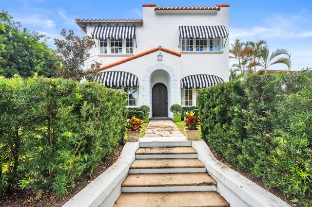 a view of a house with a flower garden