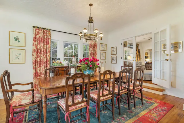 a view of a dining room with furniture and chandelier