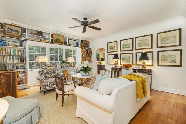 a living room with furniture and a floor to ceiling window