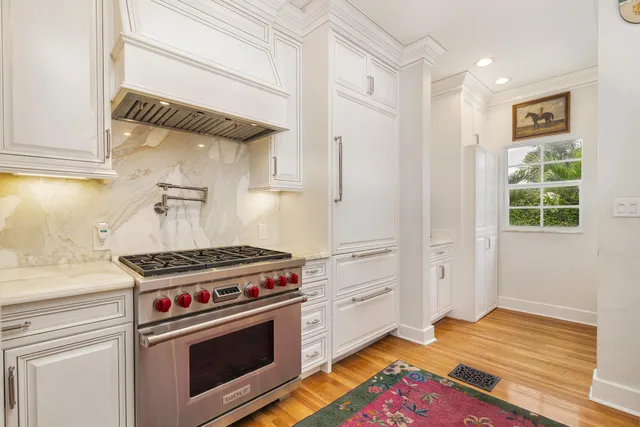 a kitchen with stove and cabinets