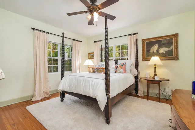 a bed sitting in a bedroom next to a window