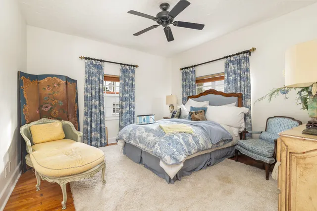 a spacious bedroom with a bed and a chandelier