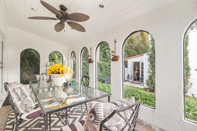 a view of a swimming pool with a dining table and chairs