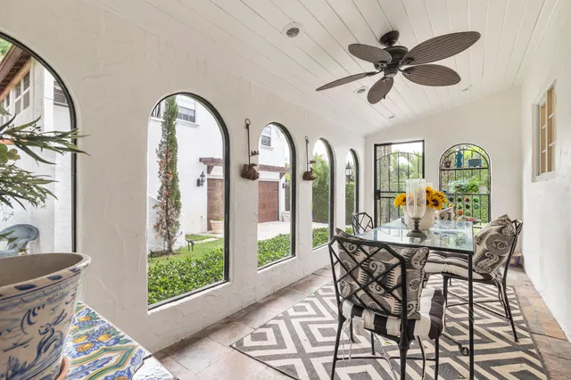 a dining room with furniture a chandelier and a rug