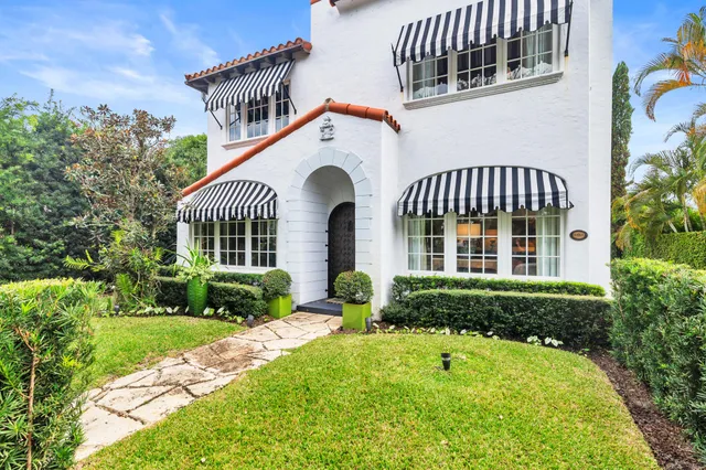 a front view of a house with garden