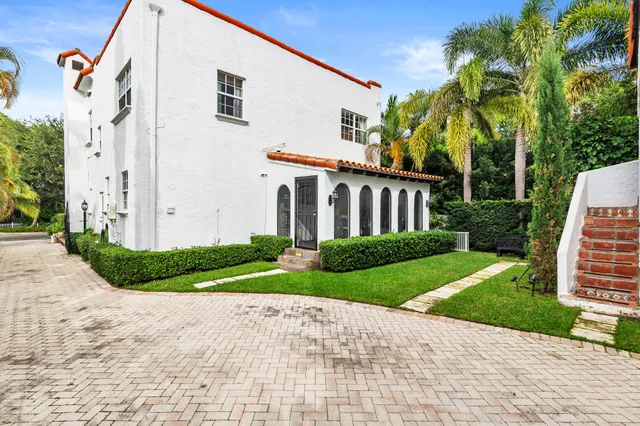 a view of a white house with a yard