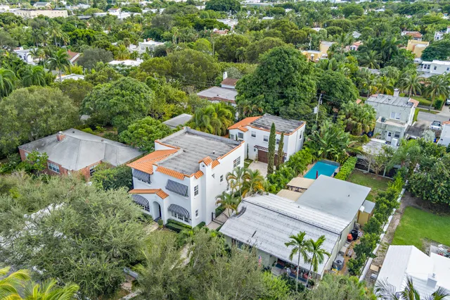 an aerial view of a house with a yard and trees