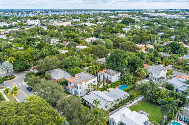 an aerial view of residential houses with outdoor space and trees