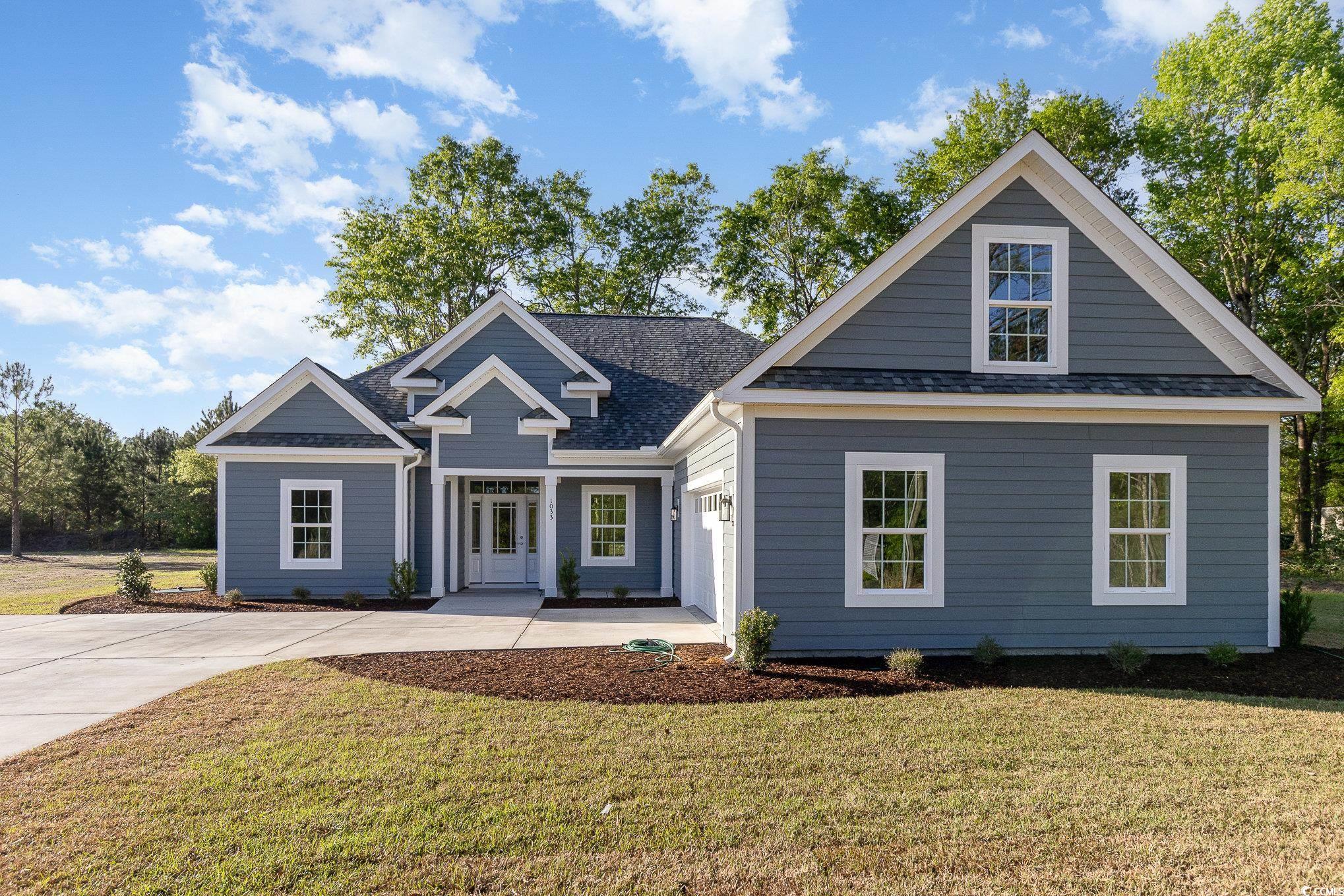 View of front of house featuring a front yard, roo