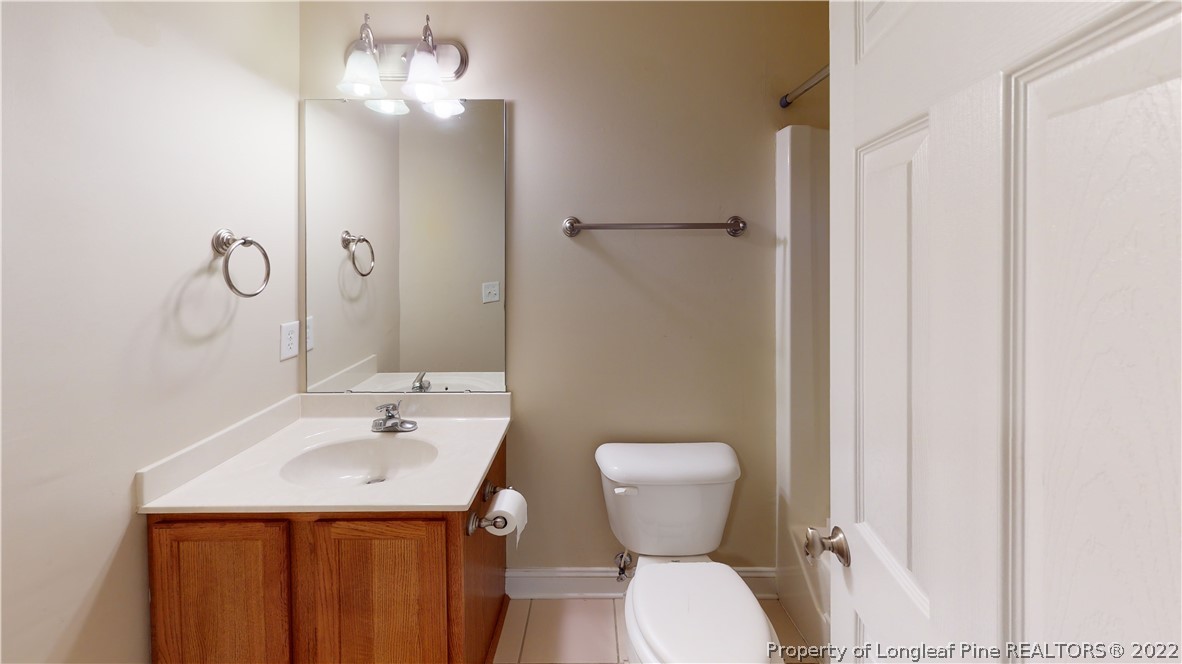 29 Hawk Ridge Drive Spring Lake, NC 28390 - Photo 18 of 33 a bathroom with a sink and mirror with toilet