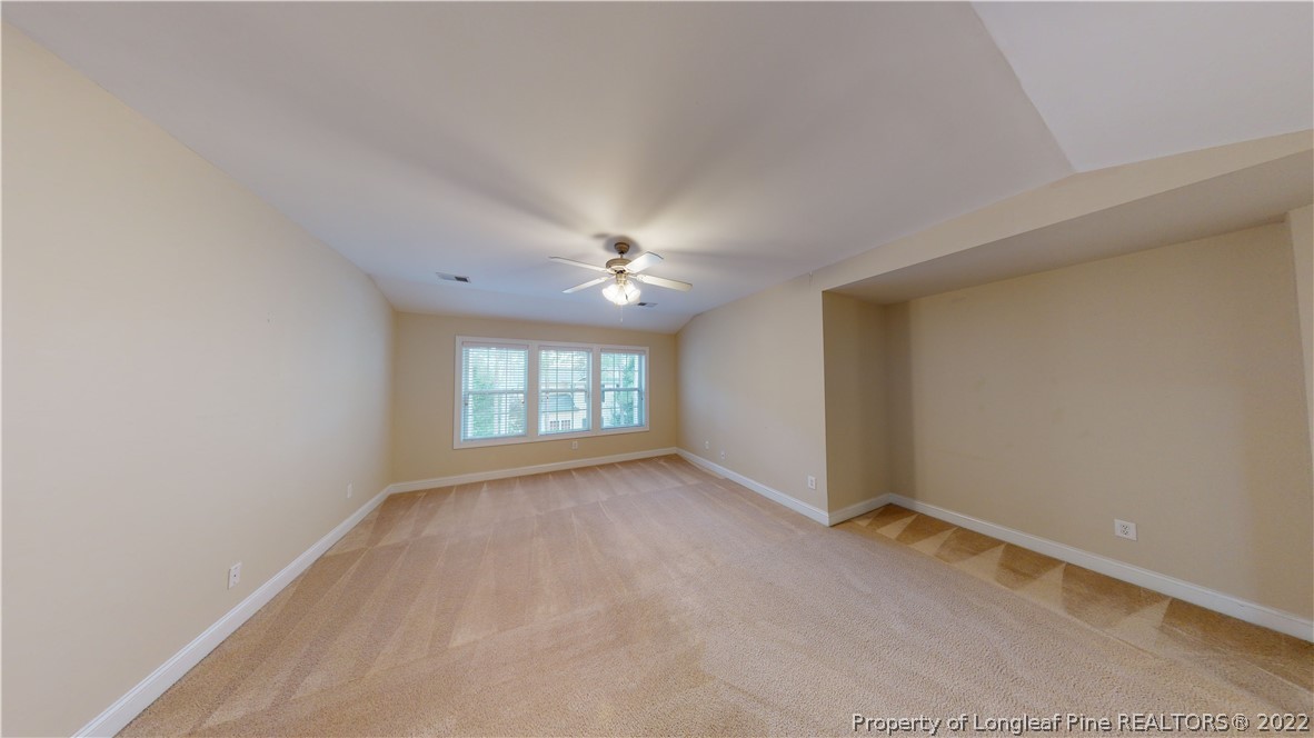 29 Hawk Ridge Drive Spring Lake, NC 28390 - Photo 25 of 33 an empty room with windows and chandelier fan