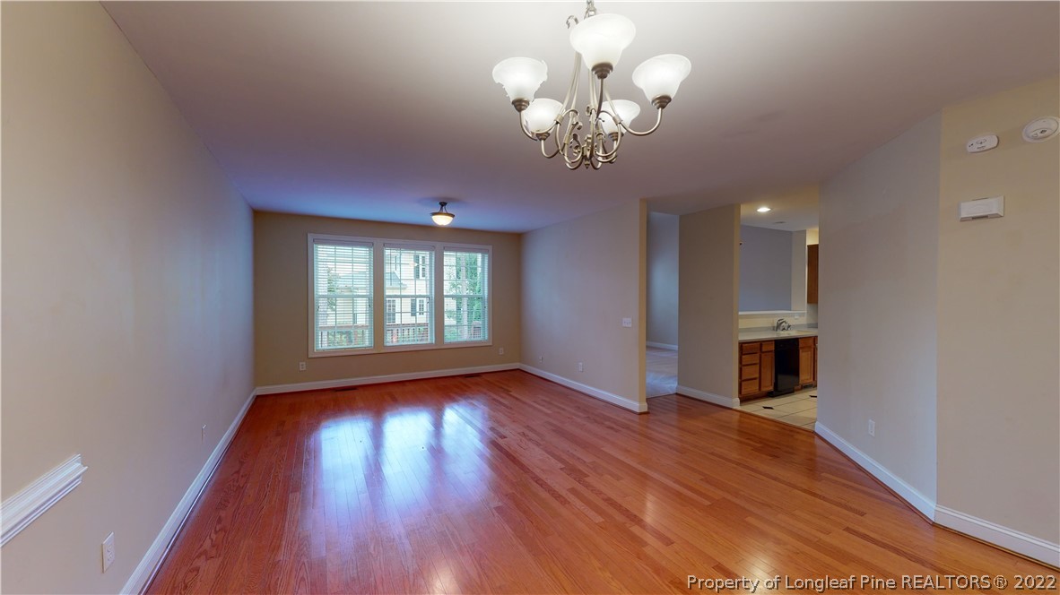 29 Hawk Ridge Drive Spring Lake, NC 28390 - Photo 4 of 33 a view of an empty room with wooden floor and a window
