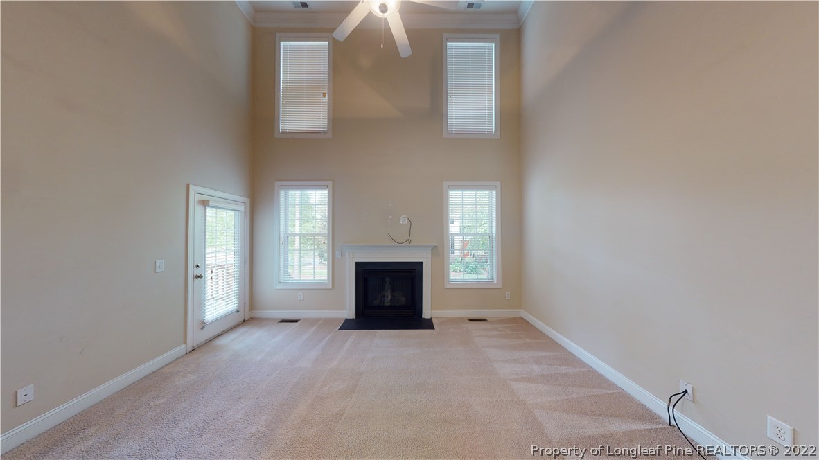 29 Hawk Ridge Drive Spring Lake, NC 28390 - Photo 7 of 33 an empty room with windows and fireplace