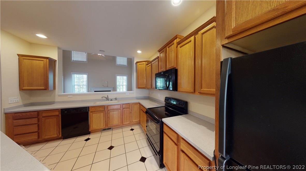 29 Hawk Ridge Drive Spring Lake, NC 28390 - Photo 10 of 33 a kitchen with a sink a stove top oven and cabinets