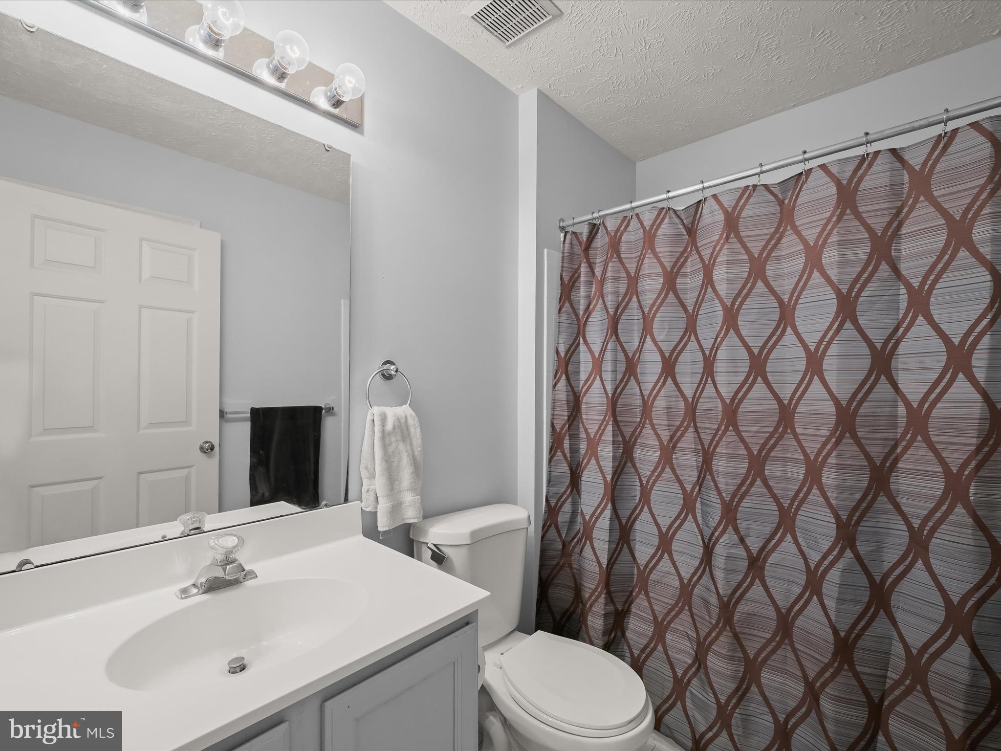 2333 Golden Chapel Road Odenton, MD 21113 - Photo 35 of 62 a bathroom with a sink a toilet and shower curtain