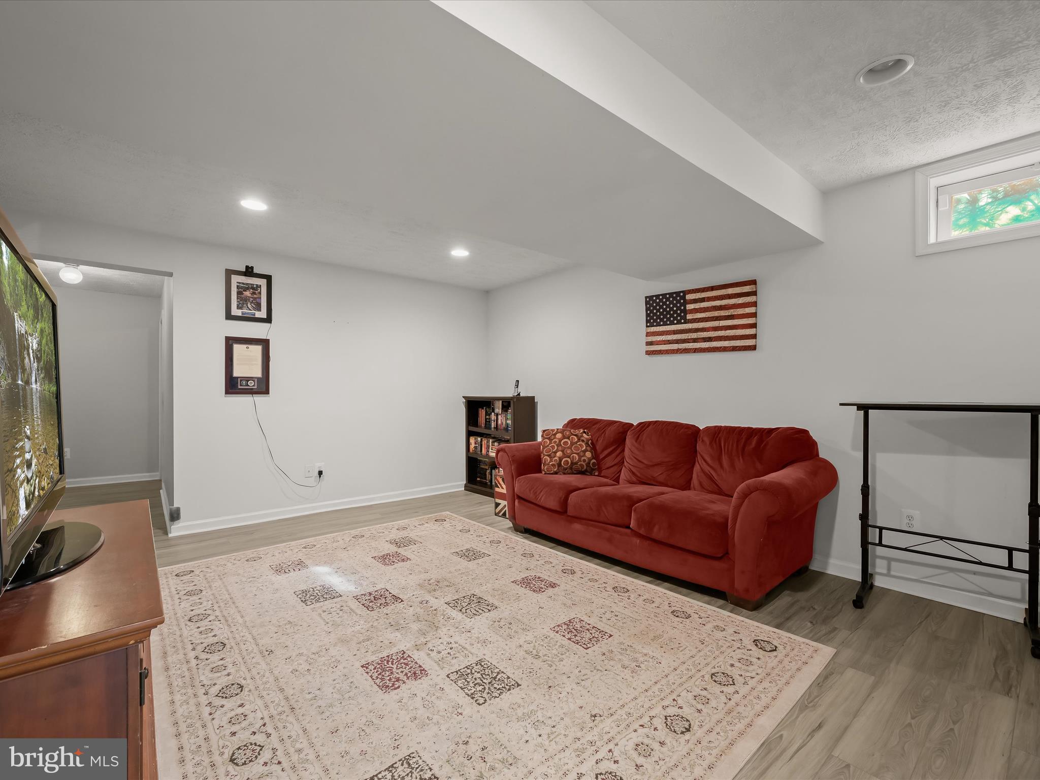 2333 Golden Chapel Road Odenton, MD 21113 - Photo 38 of 62 a living room with a couch and a flat screen tv