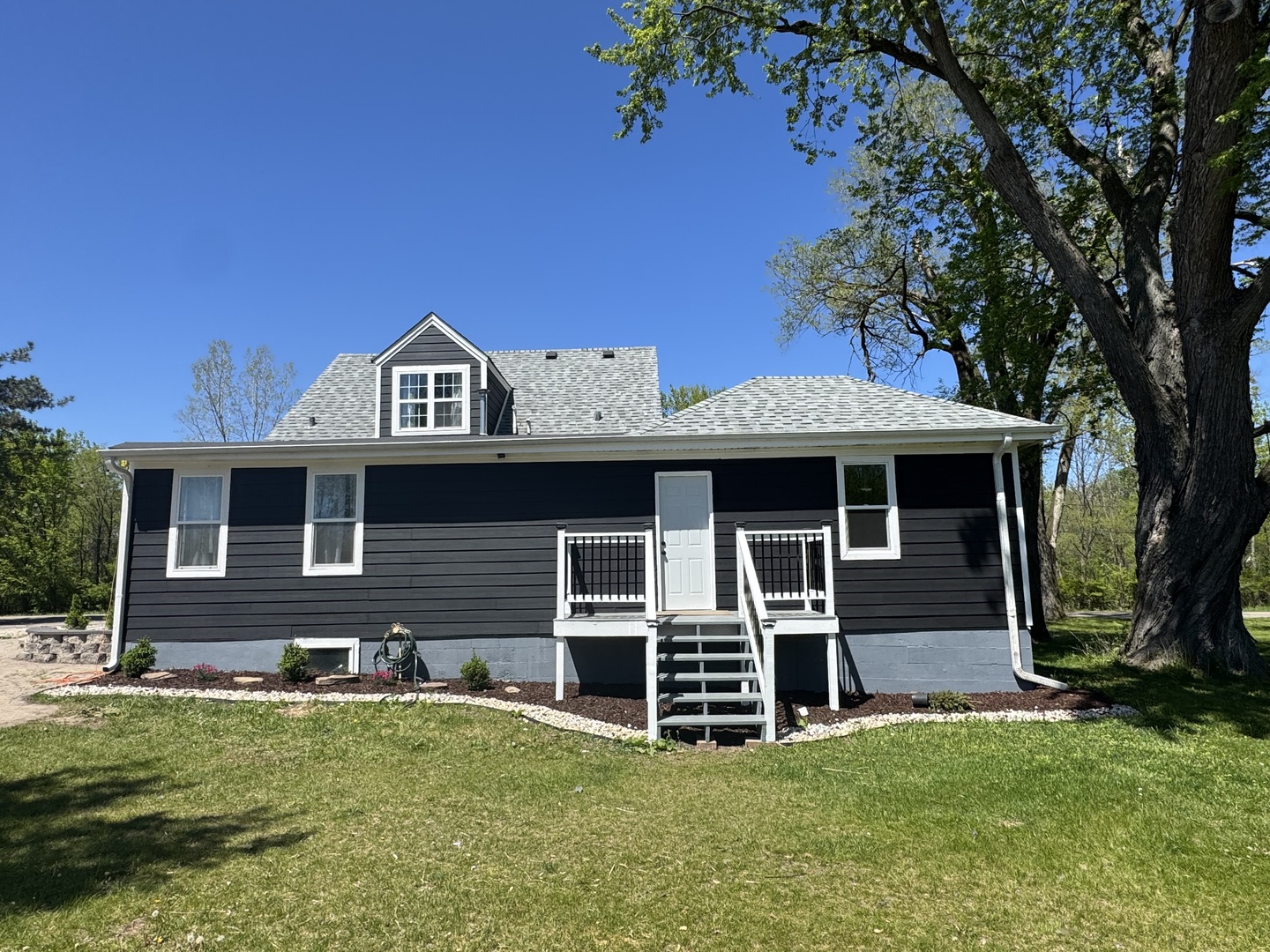 931 South Rawson Bridge Road Cary, IL 60013 - Photo 2 of 36 a front view of a house with a yard
