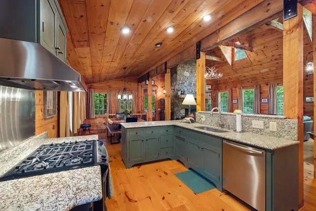 a kitchen with a sink a counter top space and stainless steel appliances