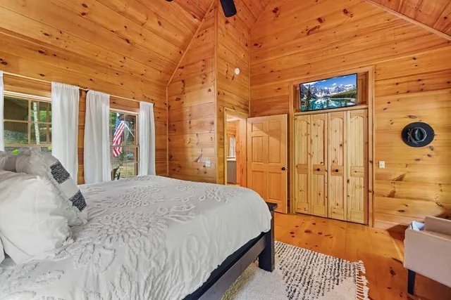 a bedroom with a bed couch and a window