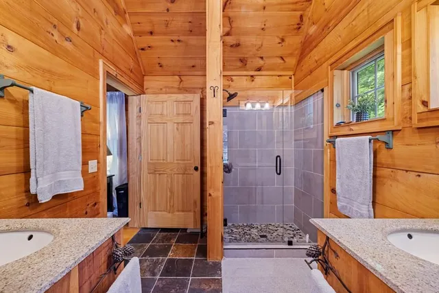 a bathroom with a granite countertop sink mirror and a bathtub