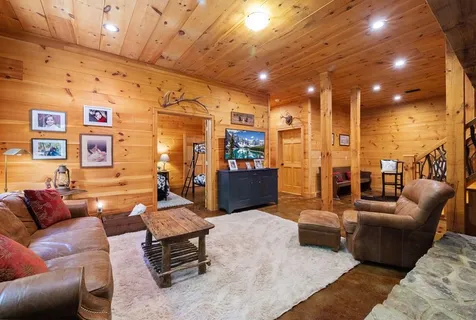 a living room with fireplace furniture and a fireplace