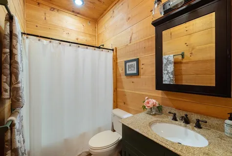 a bed room with a bed and a ceiling fan