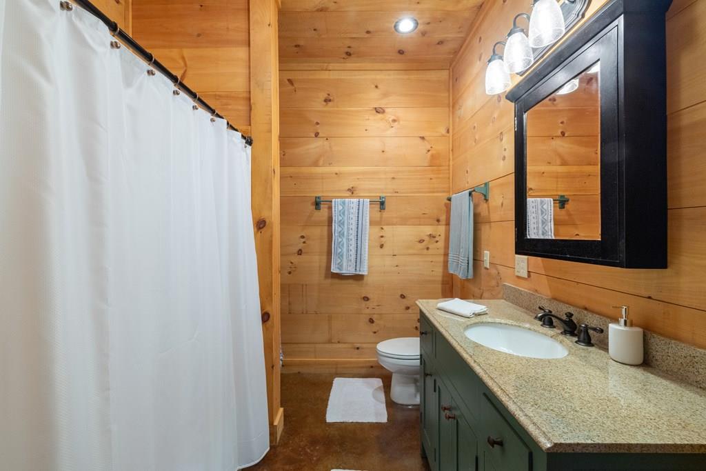 80 Tall Pines Road Morganton, GA 30560 - Photo 29 of 49 a bathroom with a granite countertop sink toilet and shower