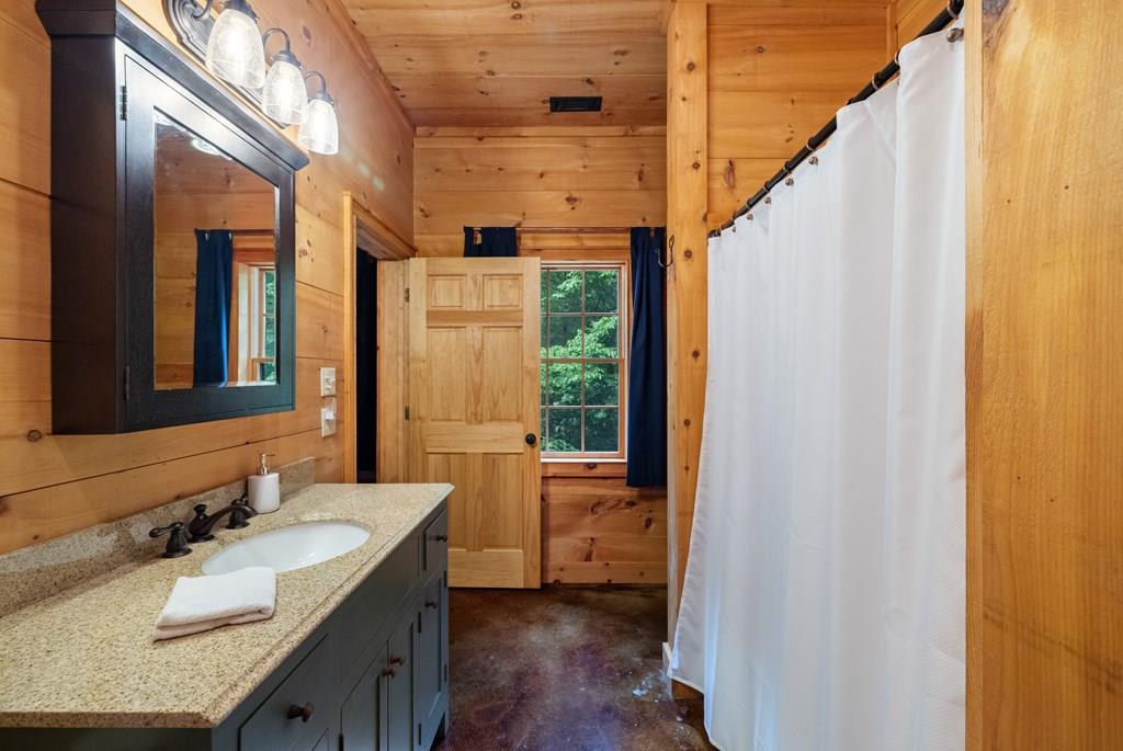 80 Tall Pines Road Morganton, GA 30560 - Photo 30 of 49 a bathroom with a granite countertop sink and a mirror