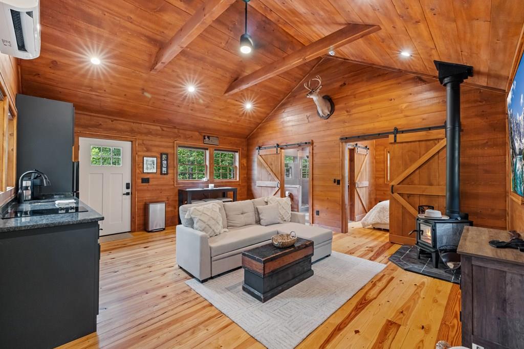 80 Tall Pines Road Morganton, GA 30560 - Photo 35 of 49 a living room with furniture and a wooden floor