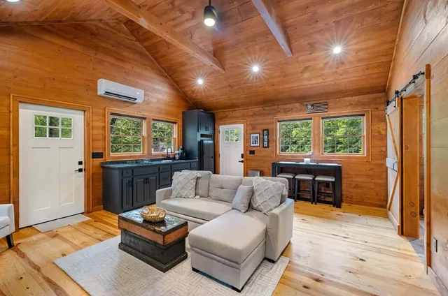 a living room with furniture and a painting on the wall