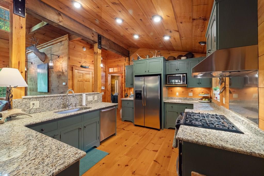80 Tall Pines Road Morganton, GA 30560 - Photo 5 of 49 a kitchen with stainless steel appliances granite countertop a sink stove and refrigerator