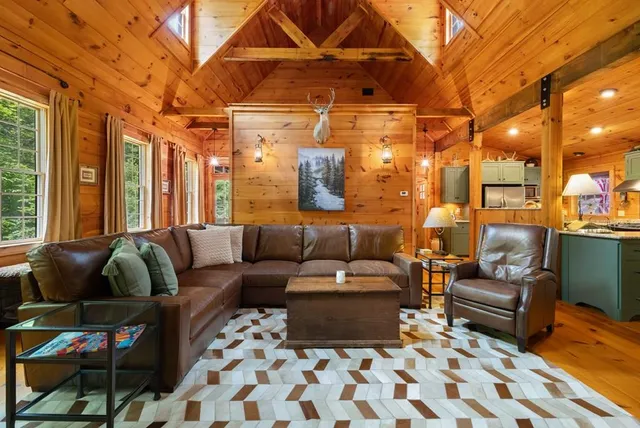 a living room with furniture and a chandelier