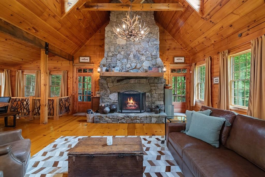 80 Tall Pines Road Morganton, GA 30560 - Photo 10 of 49 a living room with furniture a fireplace and a chandelier