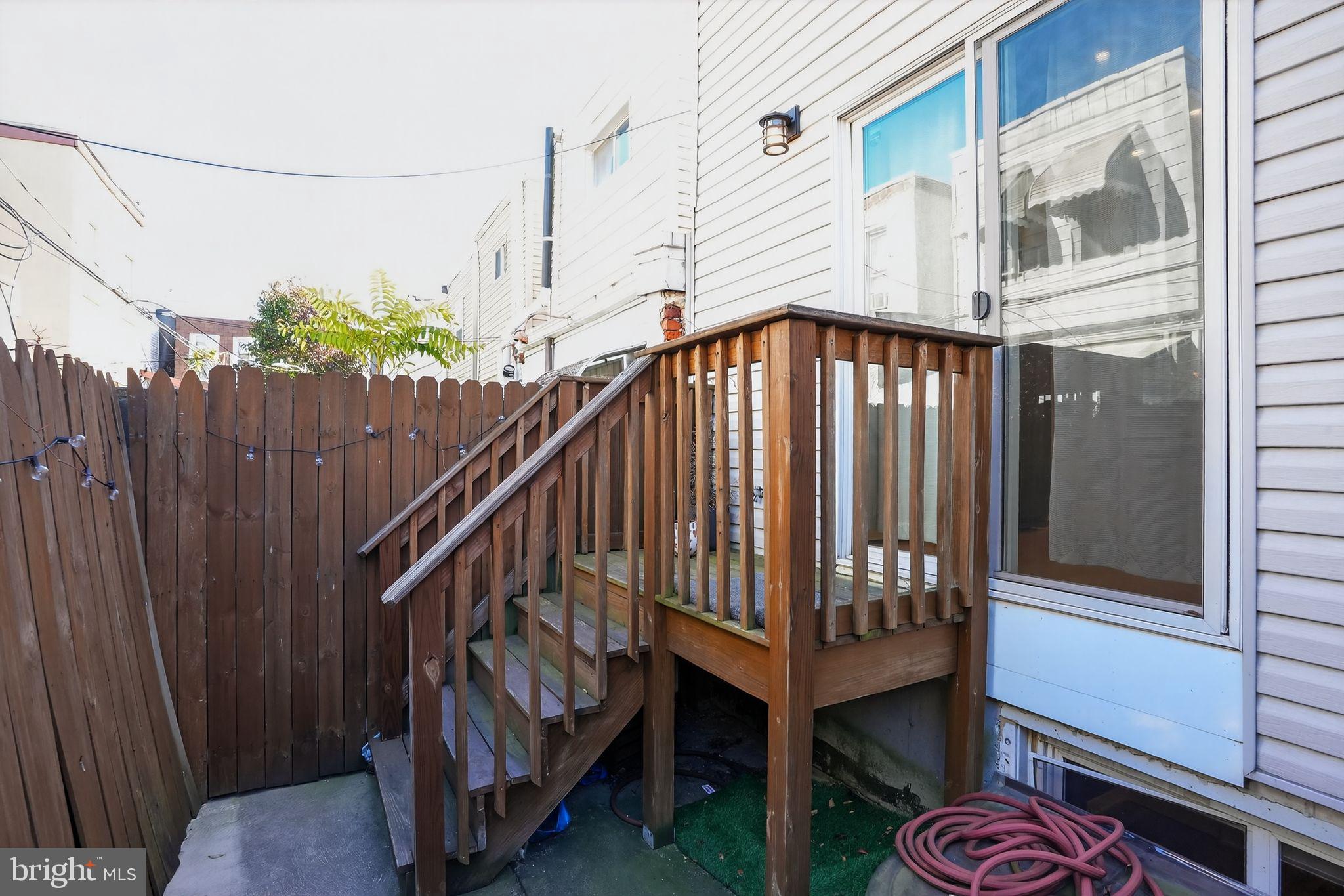 419 Emily Street Philadelphia, PA 19148 - Photo 12 of 34 a view of a house with a small yard and wooden fence