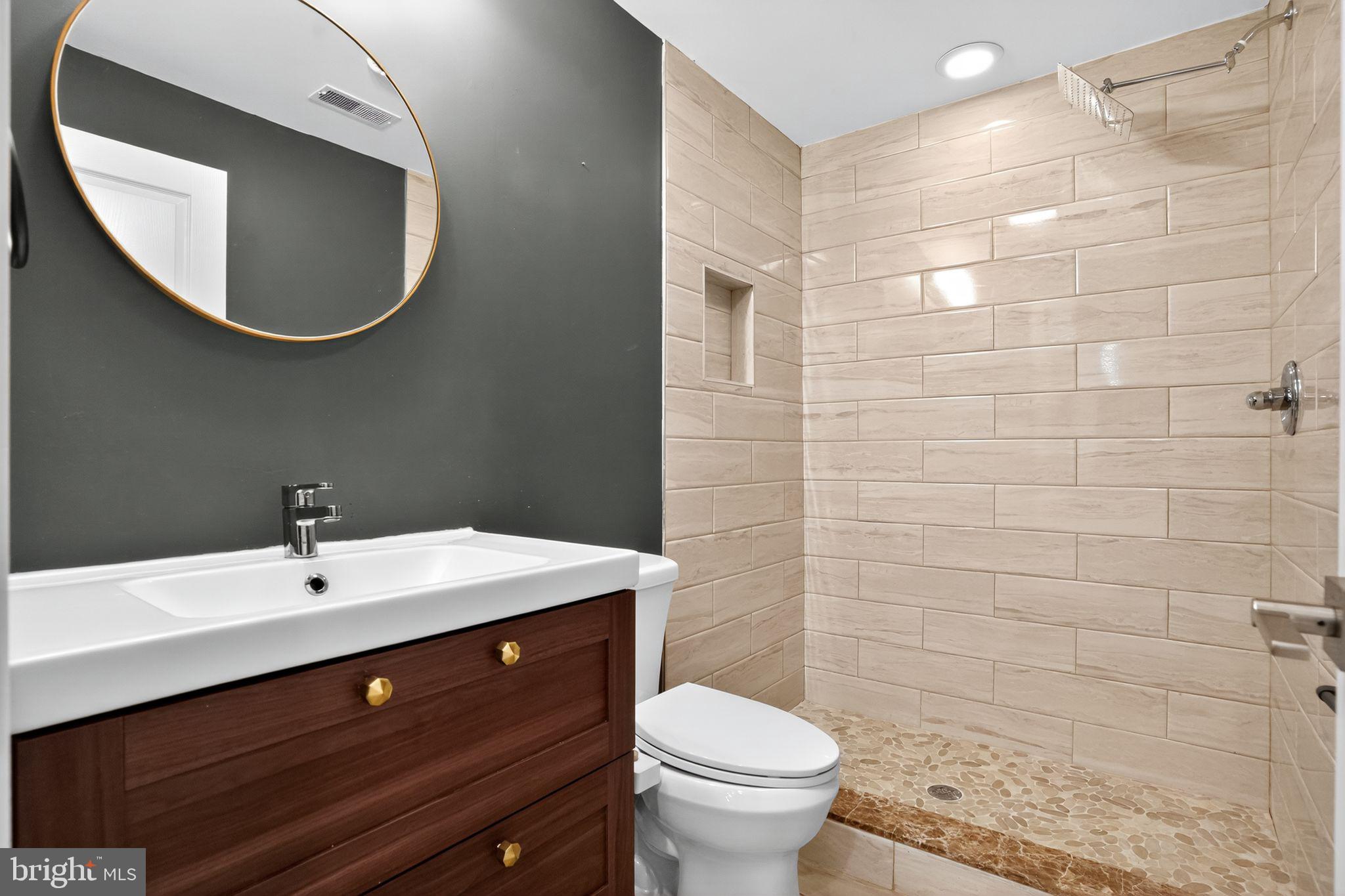 419 Emily Street Philadelphia, PA 19148 - Photo 16 of 34 a bathroom with a sink mirror and toilet