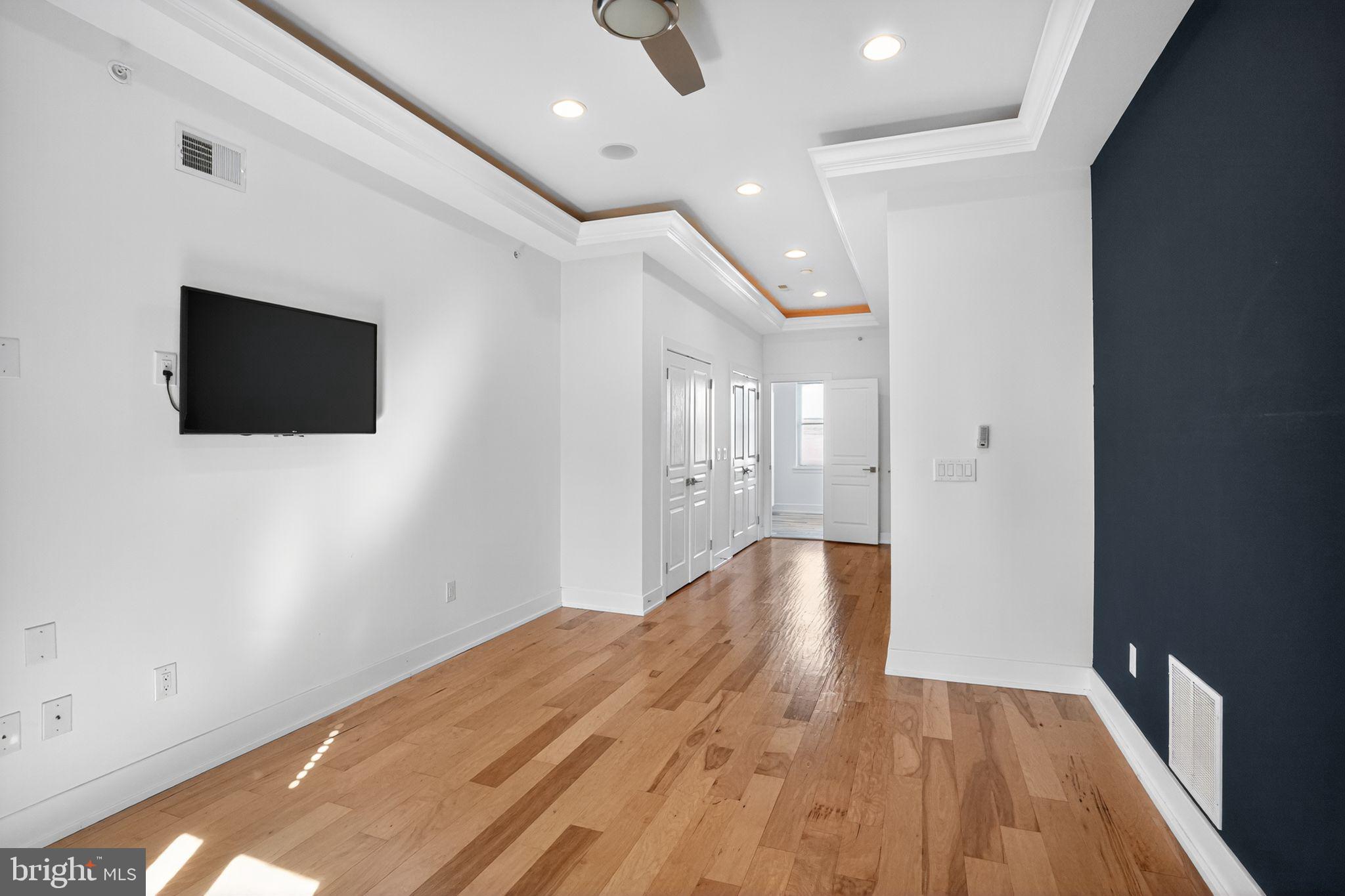 419 Emily Street Philadelphia, PA 19148 - Photo 19 of 34 an empty room with wooden floor and windows