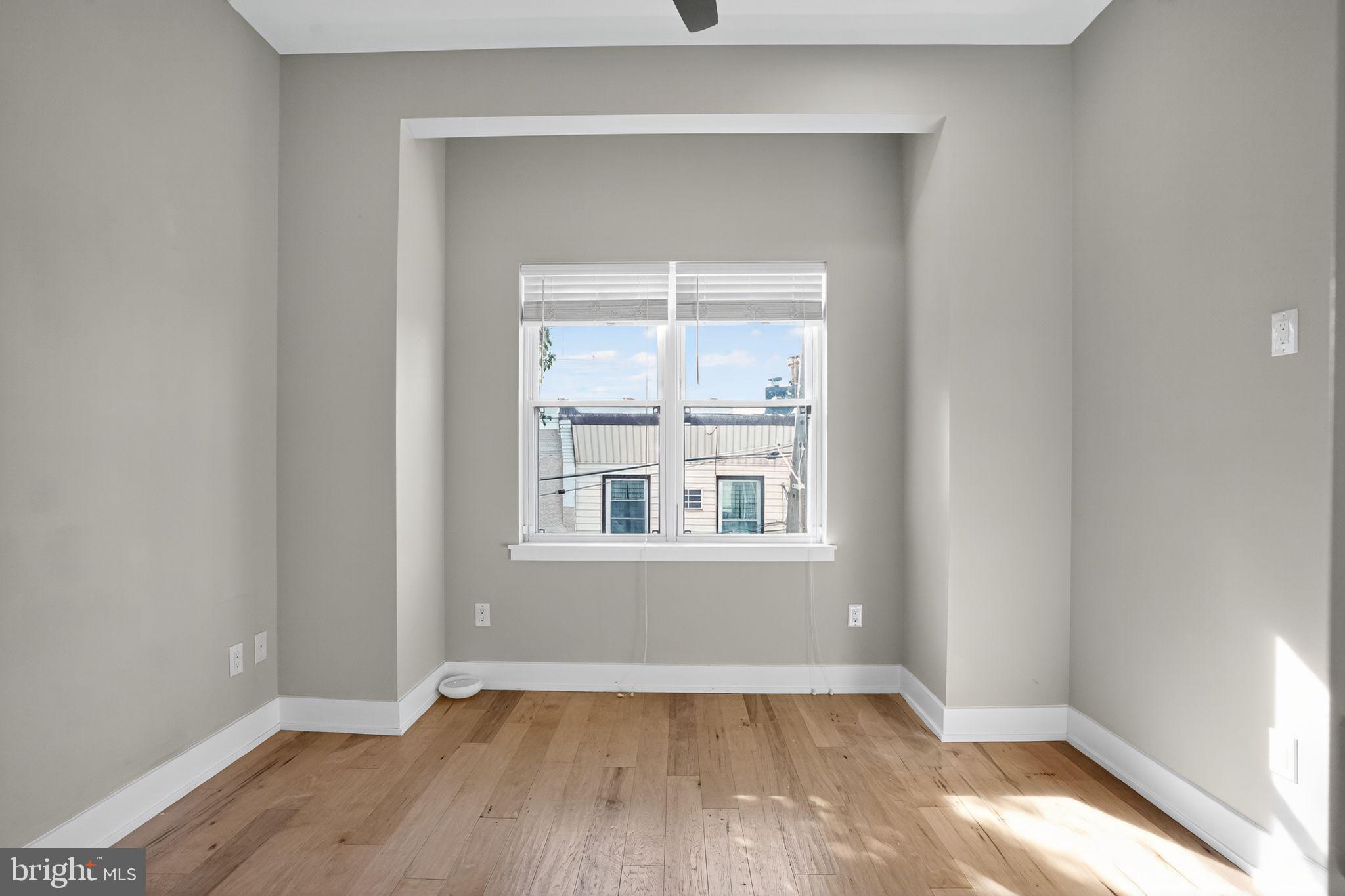 419 Emily Street Philadelphia, PA 19148 - Photo 25 of 34 an empty room with wooden floor and windows