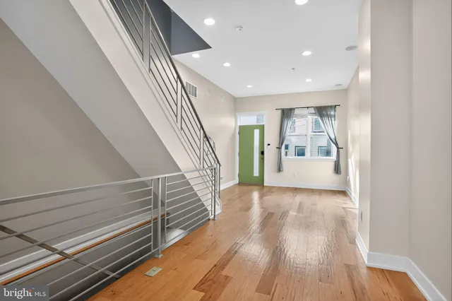 a view of an entryway with wooden floor