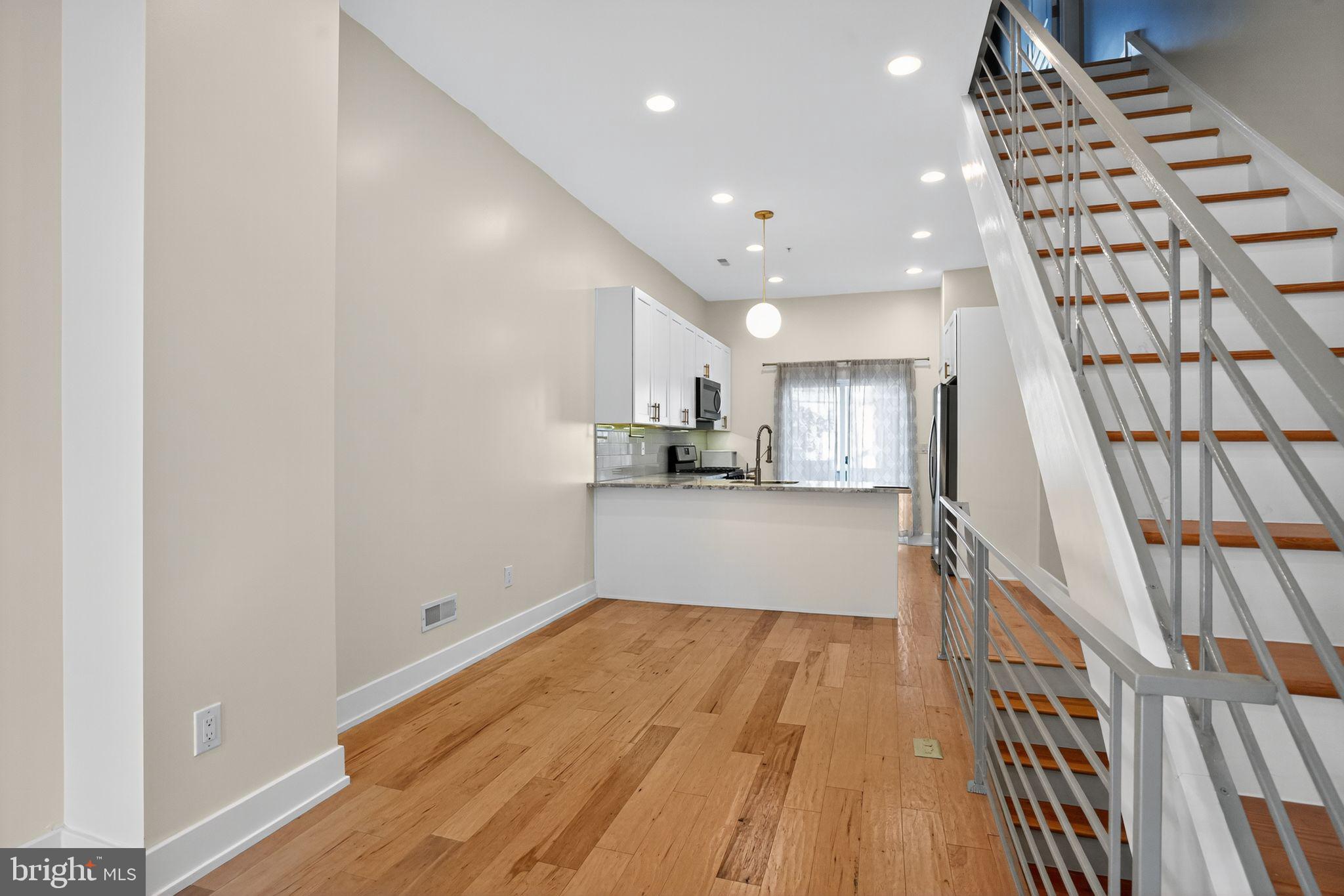419 Emily Street Philadelphia, PA 19148 - Photo 7 of 34 a view of a kitchen with wooden floor and stairs