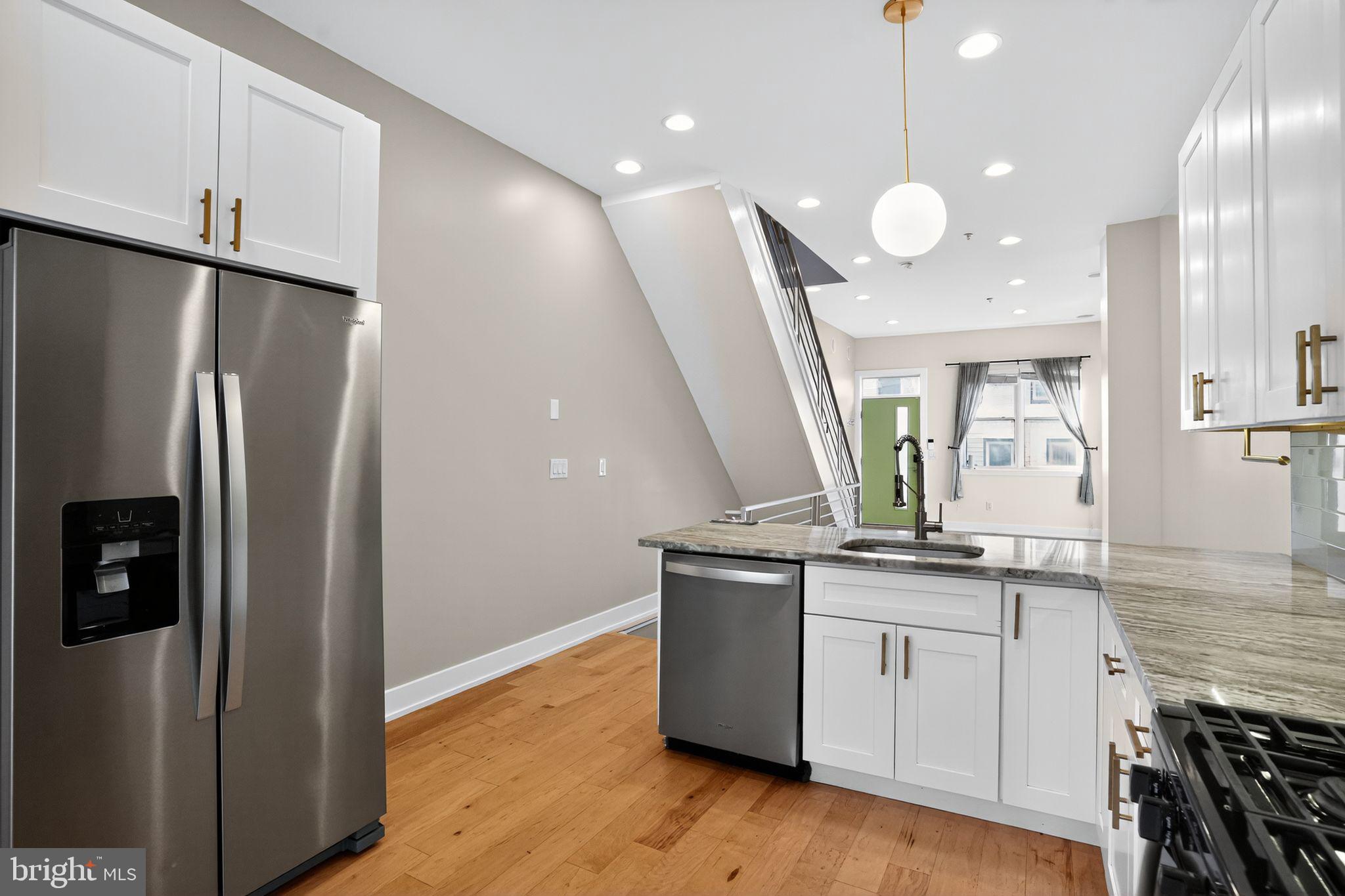419 Emily Street Philadelphia, PA 19148 - Photo 8 of 34 a kitchen with stainless steel appliances granite countertop a refrigerator a sink and a stove